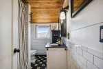 Downstairs bathroom with stackable washer/dryer at Larch St. Cottage
